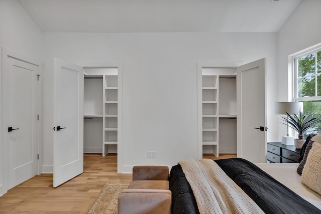 bedroom with a spacious closet, a closet, and light wood-type flooring