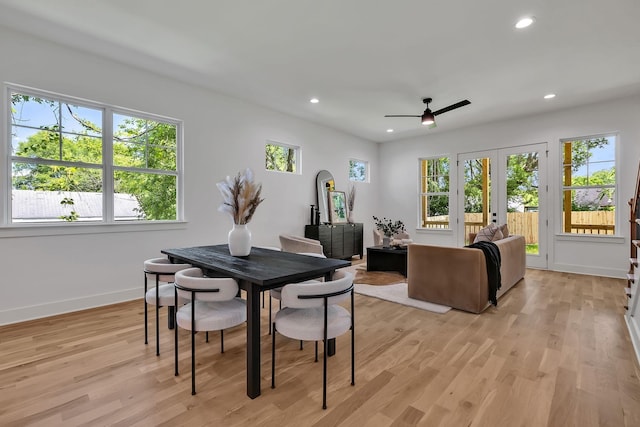 dining space with french doors and light hardwood / wood-style floors