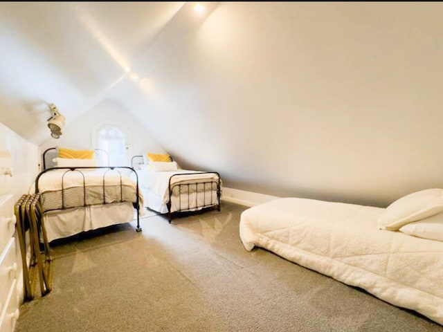 bedroom featuring vaulted ceiling and carpet floors