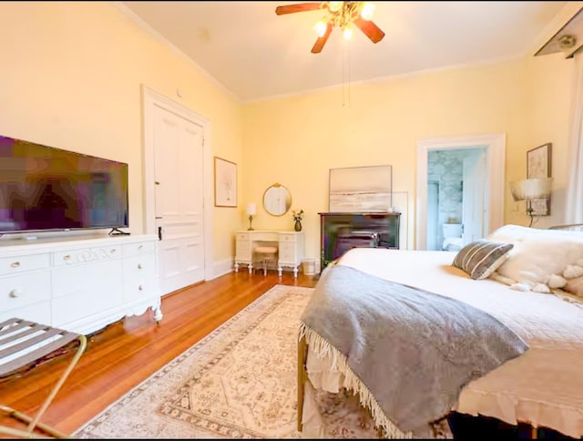 bedroom with crown molding, ceiling fan, and light hardwood / wood-style floors