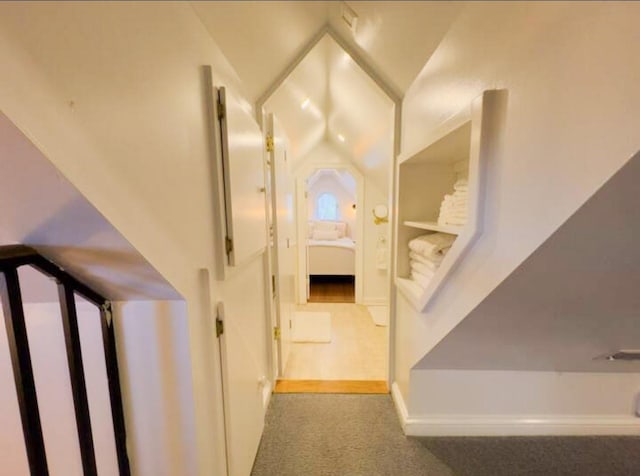 stairs featuring lofted ceiling and carpet flooring