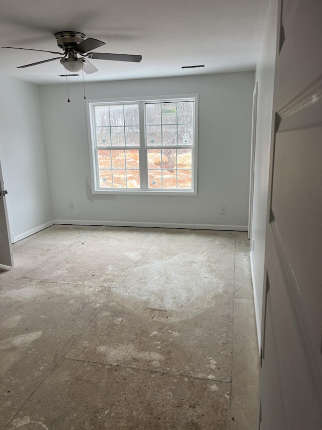 empty room with baseboards and a ceiling fan