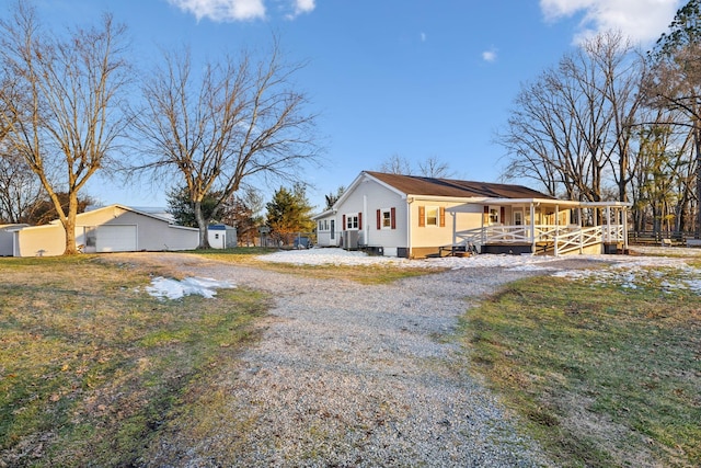 view of home's exterior with an outbuilding, a garage, and covered porch