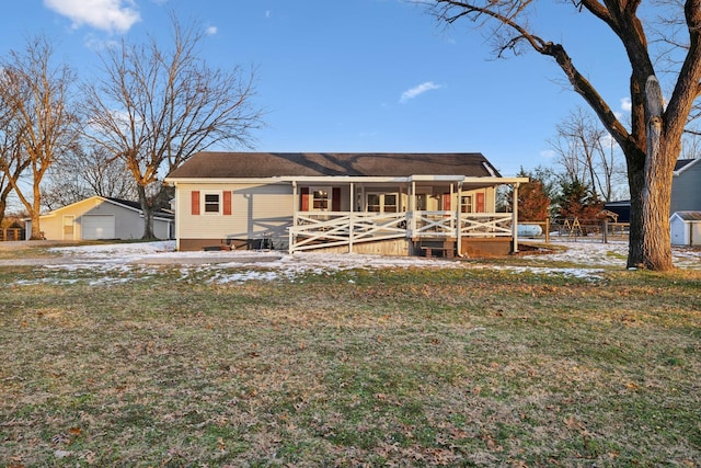 ranch-style house featuring a yard and covered porch