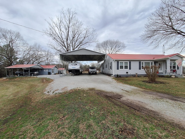 view of front of house with a front yard and a carport