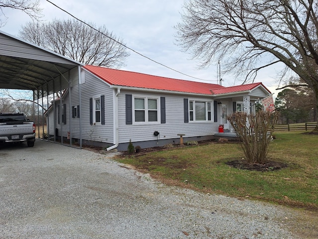 view of front of home with a carport and a front yard