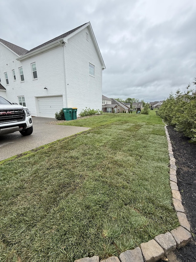9011 Safe Haven Pl, Spring Hill, TN 37174 - view of home's exterior featuring a lawn, an attached garage, concrete driveway, and stucco siding