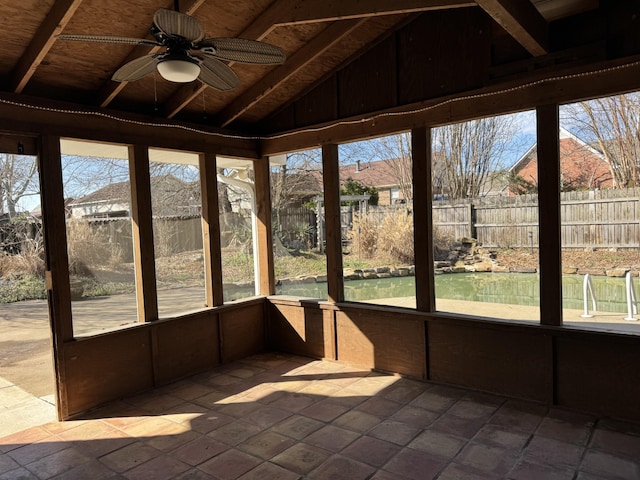 unfurnished sunroom with vaulted ceiling and ceiling fan