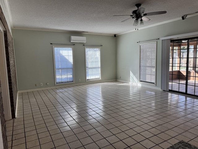 tiled spare room with ceiling fan, ornamental molding, a wall unit AC, and a textured ceiling