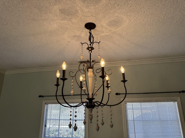 room details with ornamental molding, a textured ceiling, and a notable chandelier