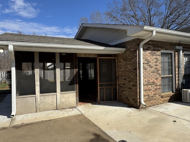 view of exterior entry featuring a patio area