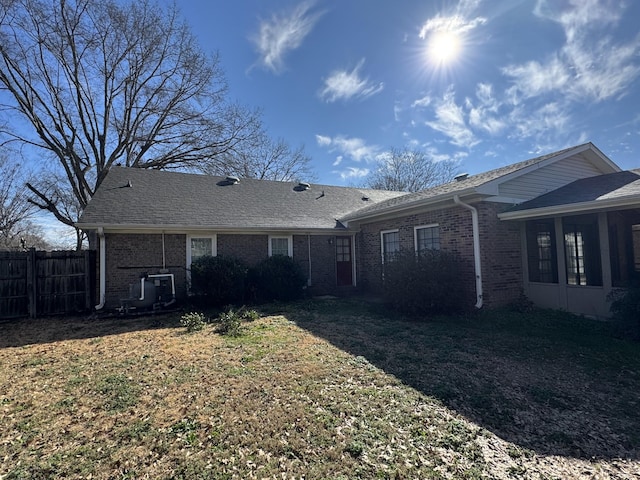 back of property featuring a lawn