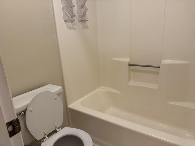 bathroom featuring toilet and tub / shower combination