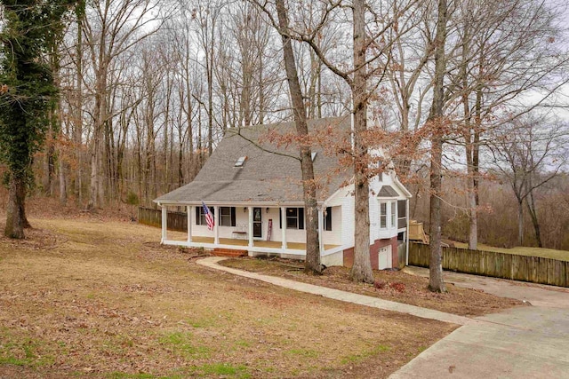 view of front facade with a porch, a garage, and a front lawn