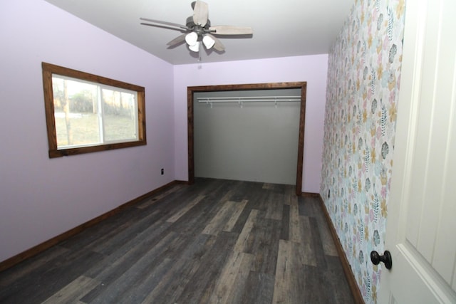 unfurnished bedroom with ceiling fan, dark hardwood / wood-style flooring, and a closet