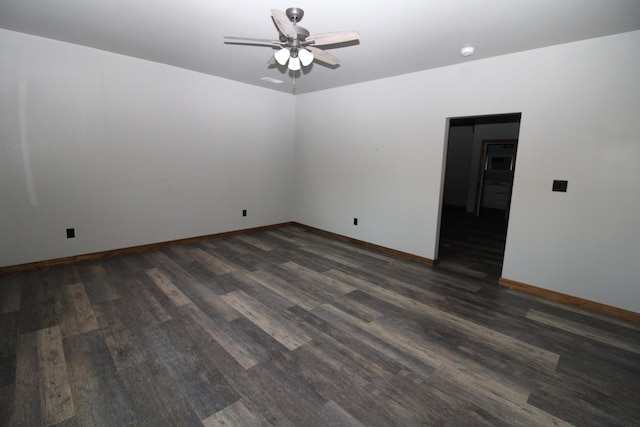 spare room with dark hardwood / wood-style floors and ceiling fan