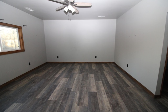 empty room with ceiling fan and dark hardwood / wood-style flooring