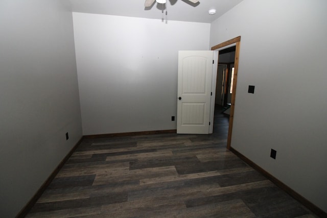 unfurnished room featuring dark wood-type flooring and ceiling fan