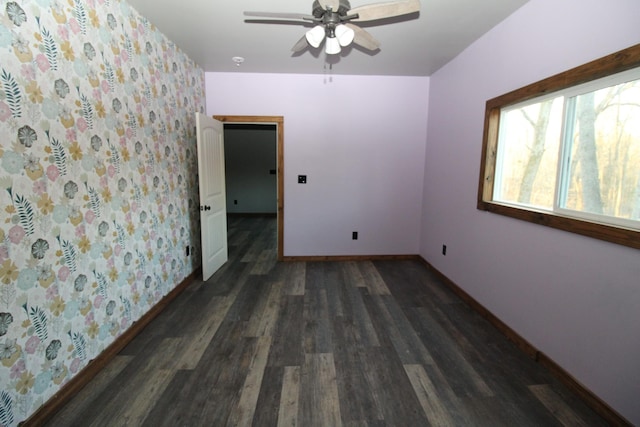 spare room with ceiling fan and dark hardwood / wood-style floors