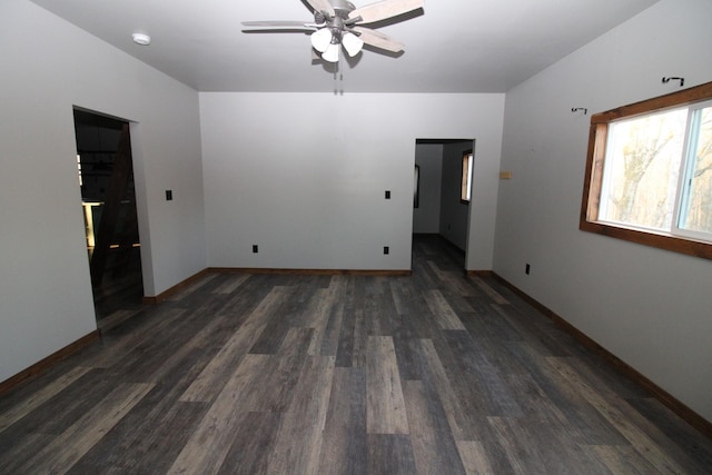 spare room with dark hardwood / wood-style flooring and ceiling fan