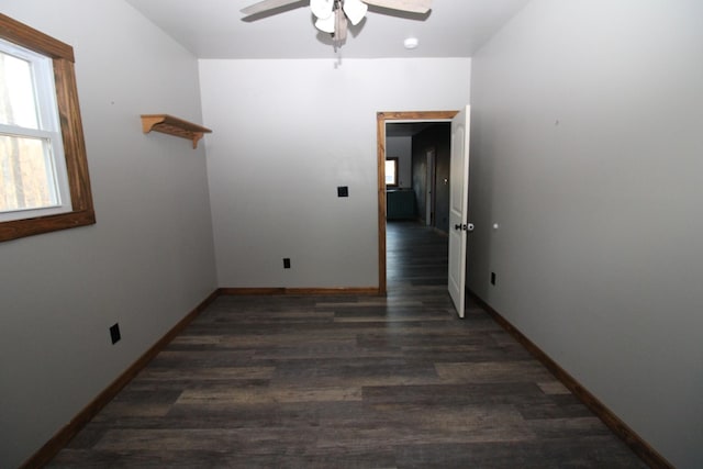 unfurnished room with dark hardwood / wood-style flooring and ceiling fan