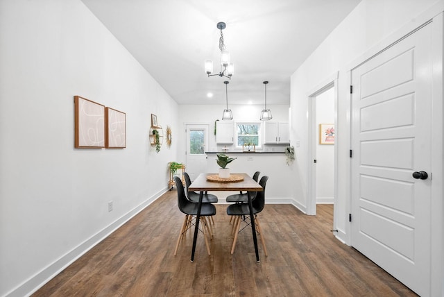 dining area with an inviting chandelier and hardwood / wood-style floors