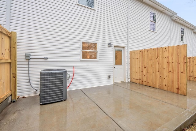 rear view of house featuring a patio area and central air condition unit