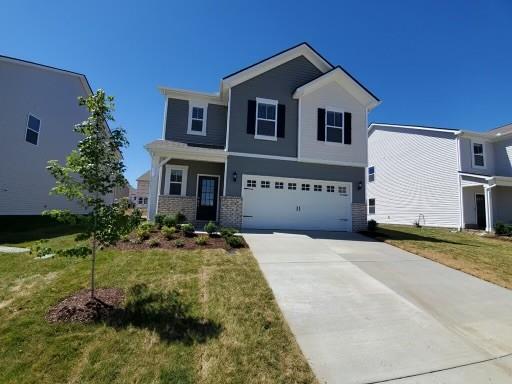 view of front of home featuring a garage and a front lawn