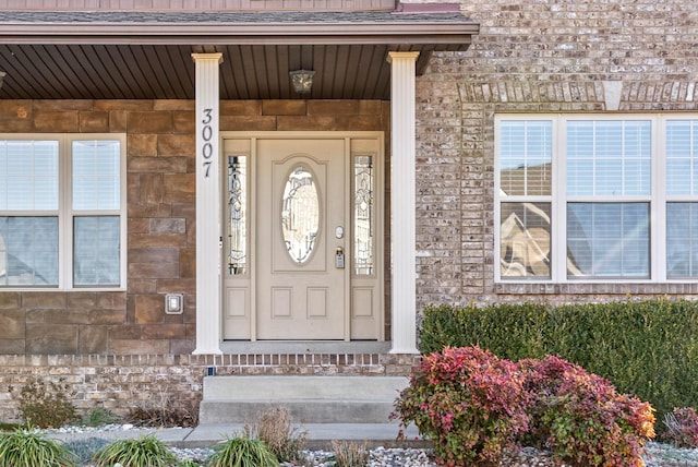 view of exterior entry with a porch