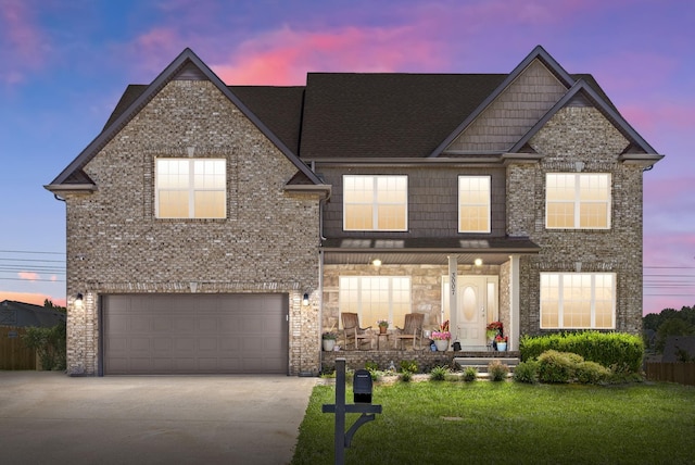 view of front of house featuring concrete driveway, a porch, a front yard, and brick siding