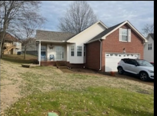 single story home featuring a garage and a front yard