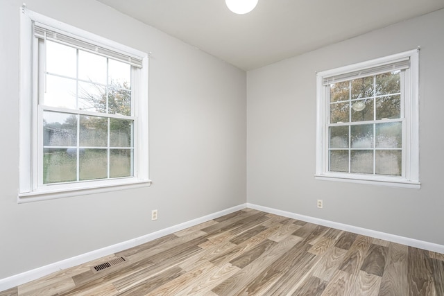 unfurnished room with light hardwood / wood-style flooring