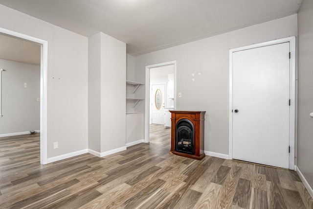 unfurnished living room with dark hardwood / wood-style flooring