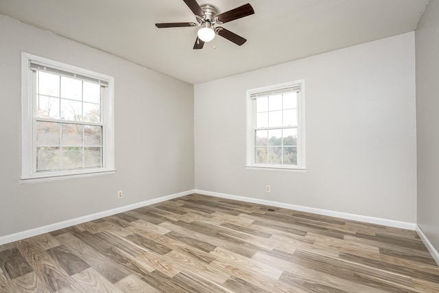 unfurnished room with hardwood / wood-style flooring and ceiling fan