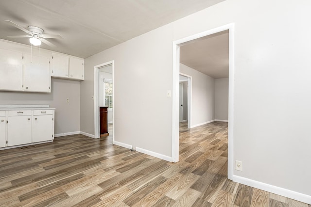 kitchen featuring white cabinetry, hardwood / wood-style floors, and ceiling fan