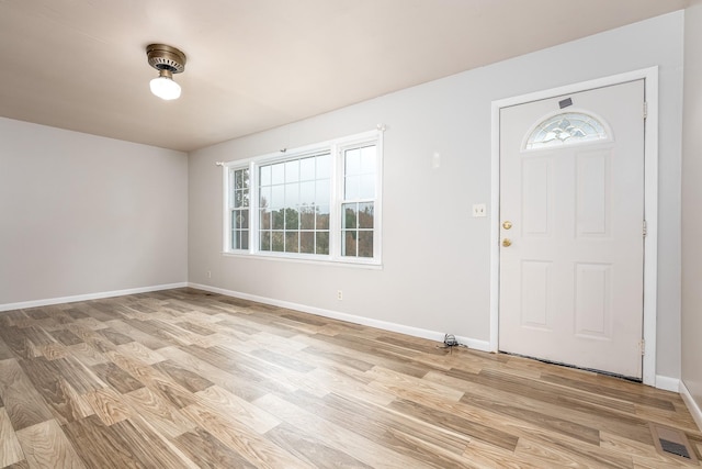 foyer entrance featuring a wealth of natural light and light hardwood / wood-style floors