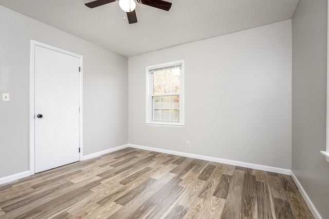 empty room with ceiling fan and light wood-type flooring