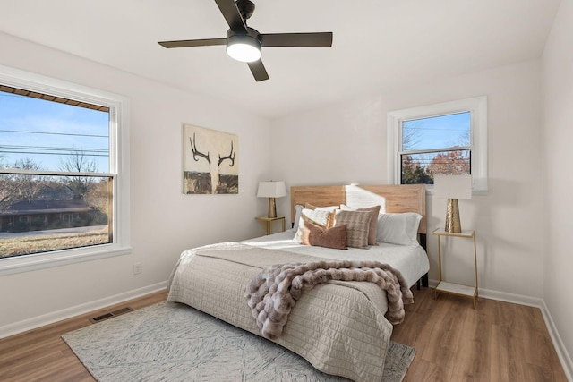 bedroom with ceiling fan and hardwood / wood-style floors