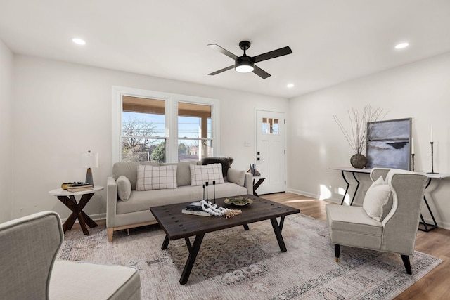 living room with ceiling fan and hardwood / wood-style floors