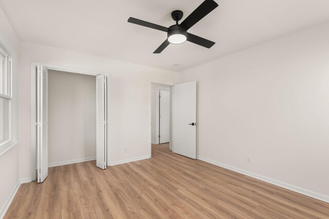 unfurnished bedroom with ceiling fan, a closet, and light hardwood / wood-style flooring