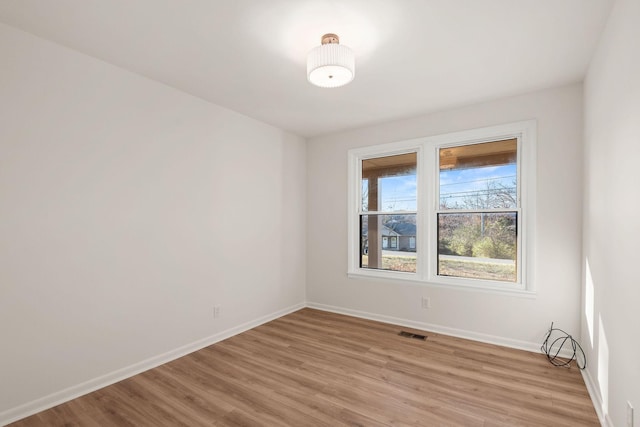 unfurnished room with light wood-type flooring