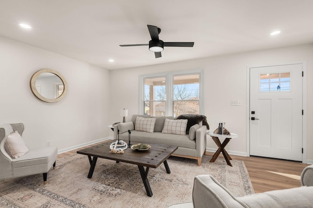 living room featuring ceiling fan and light wood-type flooring