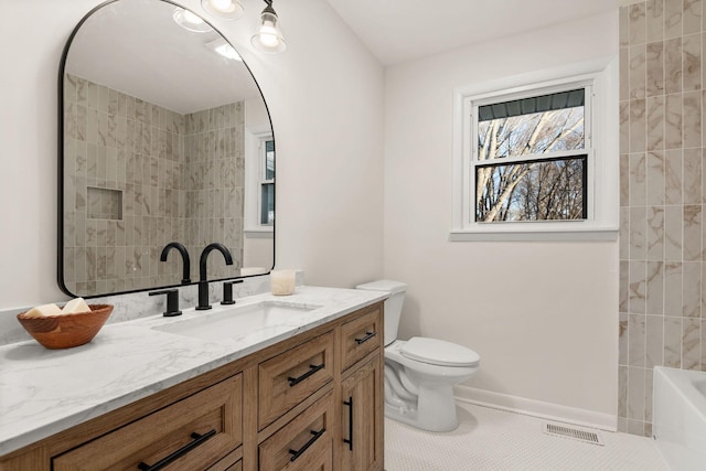 full bathroom with vanity, tiled shower / bath, tile patterned floors, and toilet