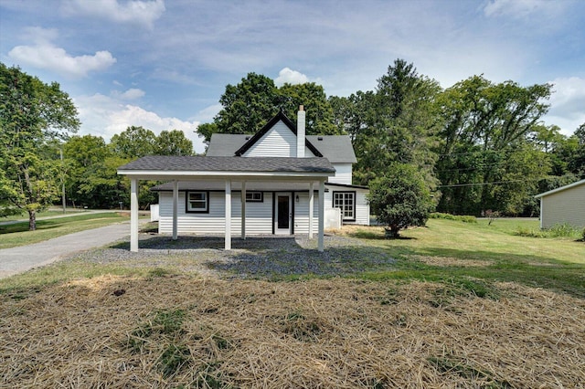 view of front of property featuring covered porch, a shingled roof, a chimney, and a front lawn