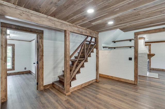 basement with dark wood-style floors, wood ceiling, and stairs