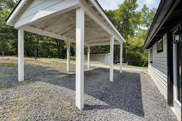 view of yard featuring driveway, a storage shed, a gazebo, an outdoor structure, and a carport