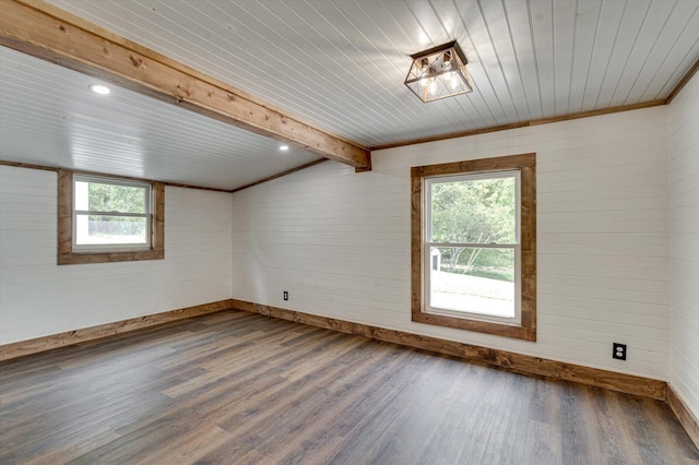 spare room with baseboards, dark wood finished floors, beamed ceiling, and ornamental molding