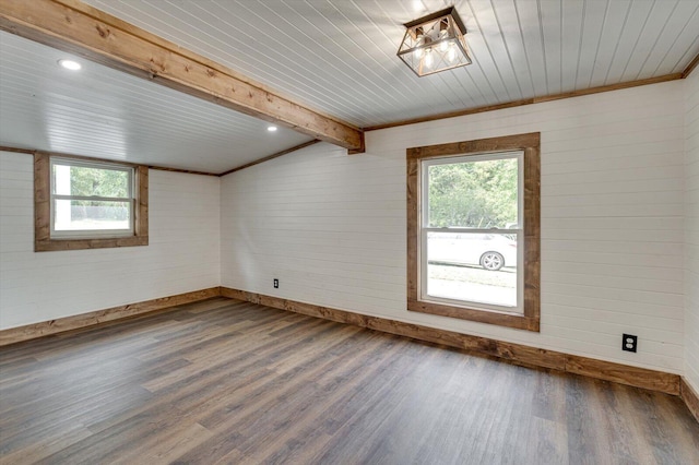 unfurnished room featuring crown molding, beamed ceiling, dark wood finished floors, and baseboards