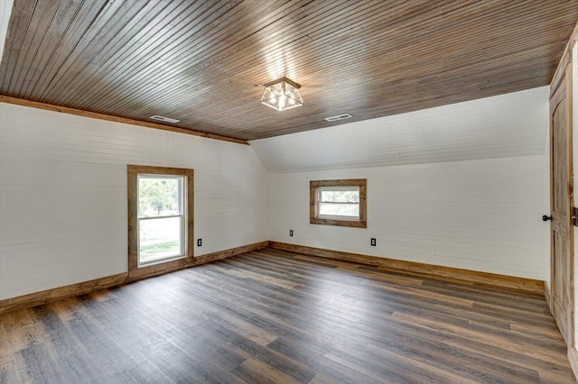 empty room featuring dark wood-style floors, plenty of natural light, and lofted ceiling