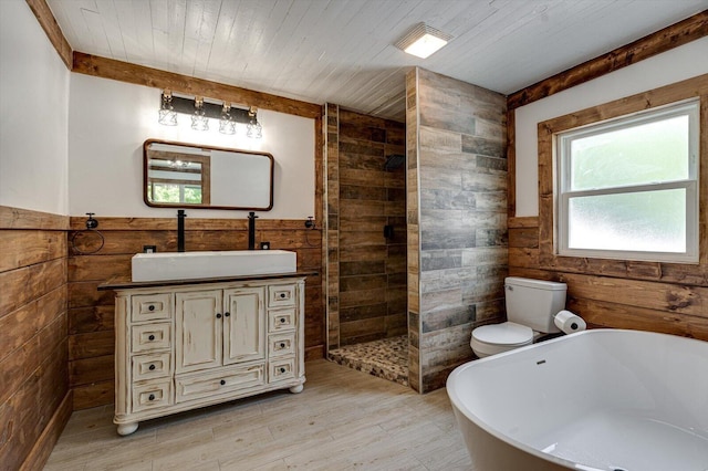 bathroom featuring wooden ceiling, a wainscoted wall, wooden walls, and vanity